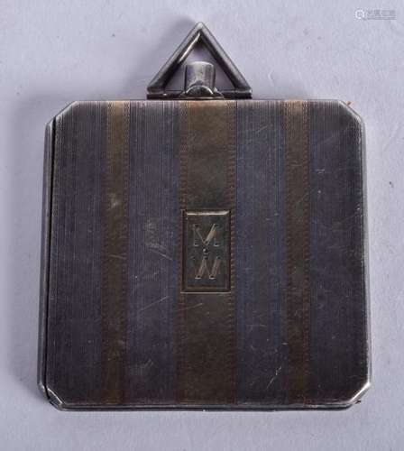 AN ART DECO GOLD AND SILVER LOCKET. 4 cm x 4 cm.