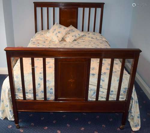 AN EDWARDIAN MAHOGANY BED, decorated with  satinwood