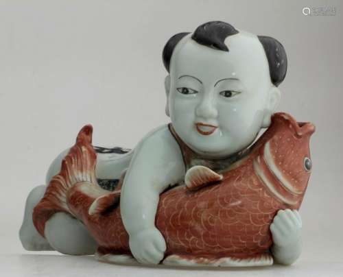 A fine Chinese porcelain boy holding a fish.