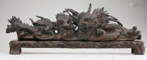 A superb wood carved dragon on a wood base.