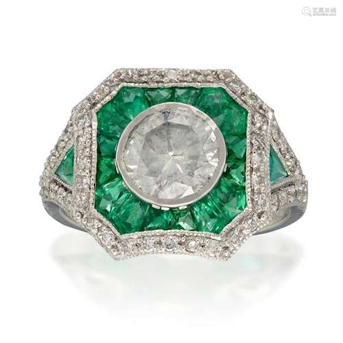 A diamond, emerald, and platinum ring,