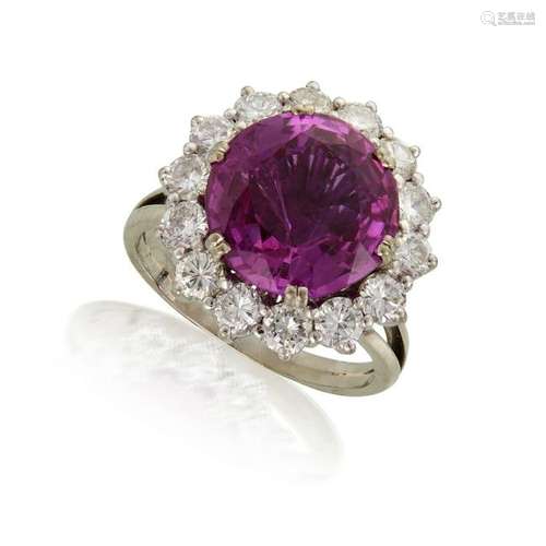 A platinum, pink sapphire, and diamond ring,