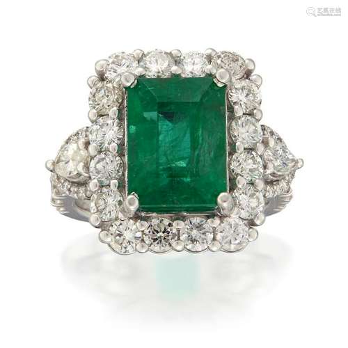 An emerald, diamond, and eighteen karat white gold