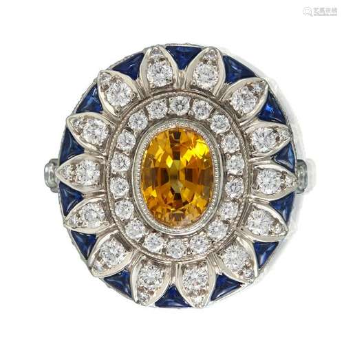 A yellow sapphire, blue sapphire, and diamond ring,