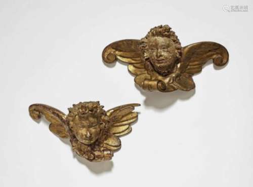 A Pair of Winged Cherub HeadsSouth German, circa 1620 Limewood, reverse flattened. Old polychrome