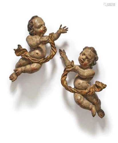 A Pair of PuttiSouth German, mid-18th Century Limewood, carved in full round, minor damage. Old