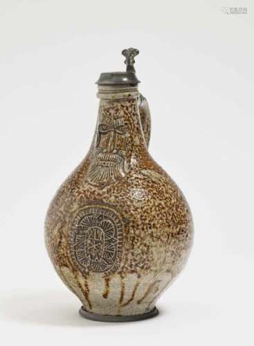 A Bellarmine jugFrechen, 17th Century Grey stoneware. Brown speckled salt glaze. Pewter cover and