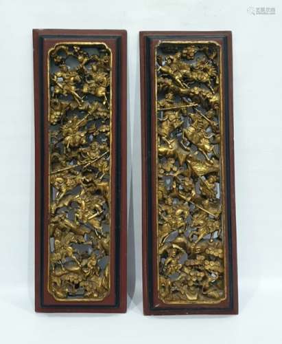 Pair Chinese carved and openwork gilt wood panels of mounted warriors in battle amid prunus trees