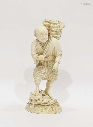 Japanese ivory okimono, late 19th century, modelled as a fisherman carrying a basket of fish over