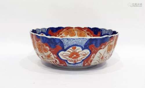 Japanese Imari fluted circular bowl, the interior painted with a jardiniere of flowers on a terrace,