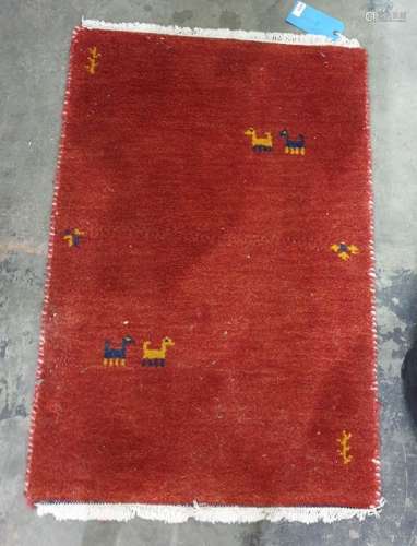 Modern red ground rug decorated with animals, 89.5cm x 61cm