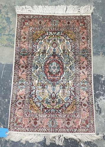 Two Eastern rugs, one white ground with central pink ground stepped foliate medallion, foliate