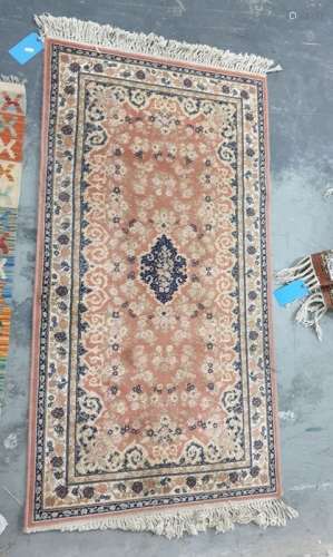 Modern peach ground rug with central medallion foliate decorated field and stepped border, 156cm x