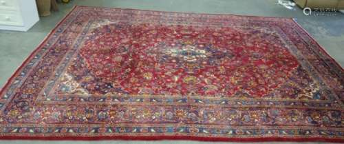 Red ground rug with stepped central foliate decorated medallion, the field with allover foliate
