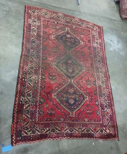 Red ground rug with three black ground interlinking central medallions, on a stepped border, 265cm x