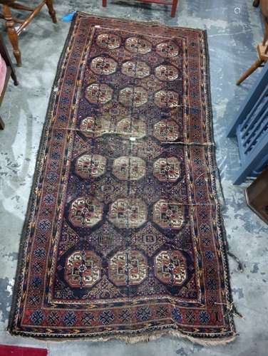 Belouch rug, blue ground, central field with 21 elephant foot guls interspersed with diamond
