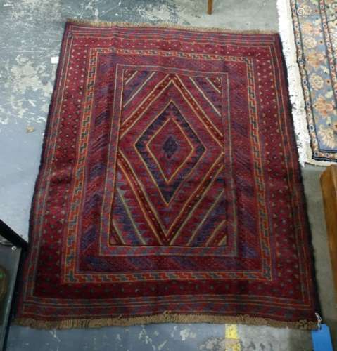 Eastern rug with central stepped diamond shaped medallion on a stepped border, in plum red, midnight