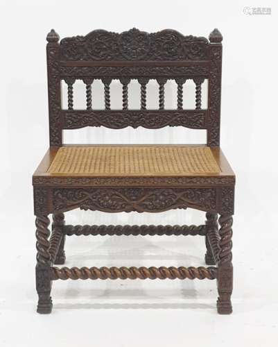 Anglo Indian style cane seated chair, the elaborately carved back and rail on barleytwist supports