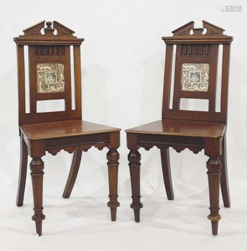 Pair of 19th century mahogany hall chairs with broken arch top rails, the back splats featuring