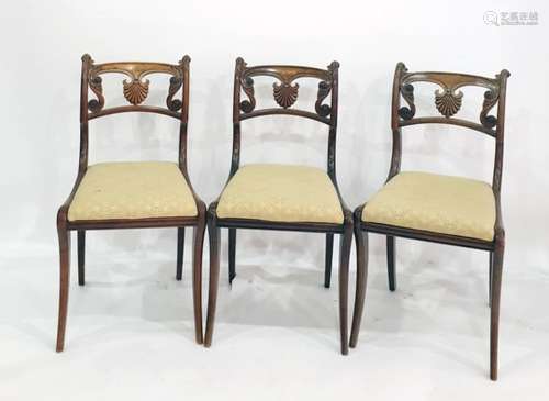 Set of four Regency simulated rosewood dining chairs with anthemion and scroll carved backs, gold