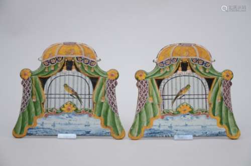A pair of polychrome Dutch plaques 'bird cage' (25x21cm)