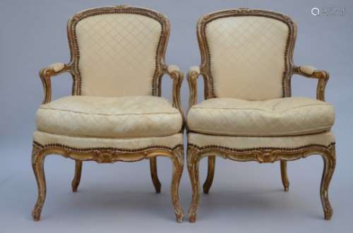 A pair of patinated Louis XV style armchairs
