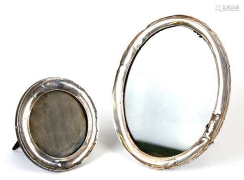 An oval silver strut photograph frame; together with a circular silver strut photograph frame (2).