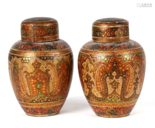 A pair of Persian / Indian lacquered vases and covers decorated with stylised flowers, 10cms (