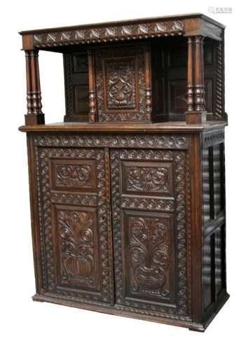 An 18th century and later oak court cupboard, the upper section with central cupboard supported by