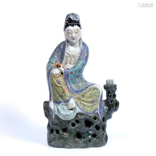 Famille rose porcelain model of Guanyin Chinese depicting seated cross legged with one hand