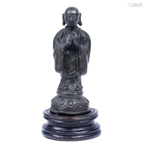 Bronze figure Sino-Tibetan, 19th Century a shaven headed Buddhist priest in long robes with floral