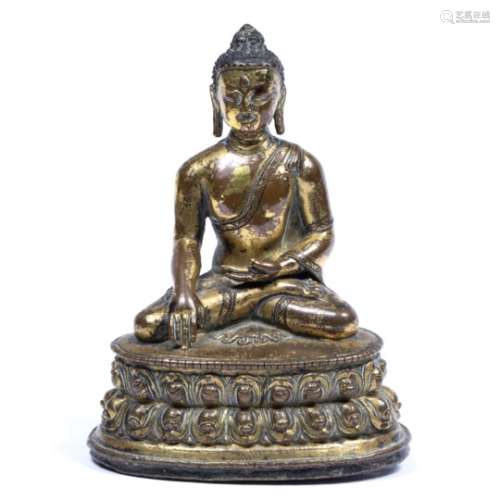 Gilt bronze figure of Gantama Buddha Tibetan, 18th Century seated in mudra on lotus base, foot