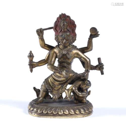 Gilt bronze figure of a wrathful deity Tibetan, 17th Century with three faces and six arms holding