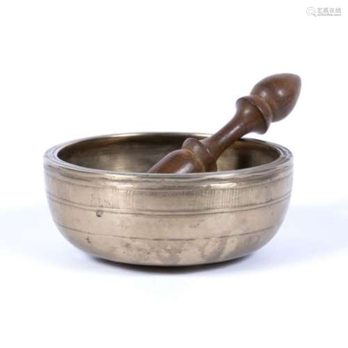 Bronze singing bowl Tibetan, 18th Century engraved with lines to the outside 5cm high, 13.5cm across