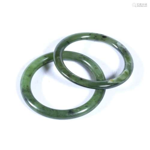 Two jadeite bangles Chinese of plain form 8cm and 7.75cm diameter (2)