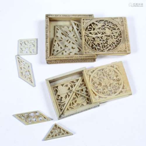 Two ivory puzzle boxes each decorated with birds and flowers both 6cm across (2)