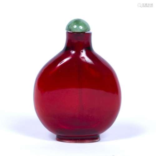 Red glass snuff bottle Chinese of rounded form with a slightly raised foot, with a green stone