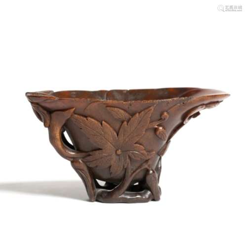 Rhinoceros libation cup Chinese, 18th Century carved in relief with a chi-lin style dragon set