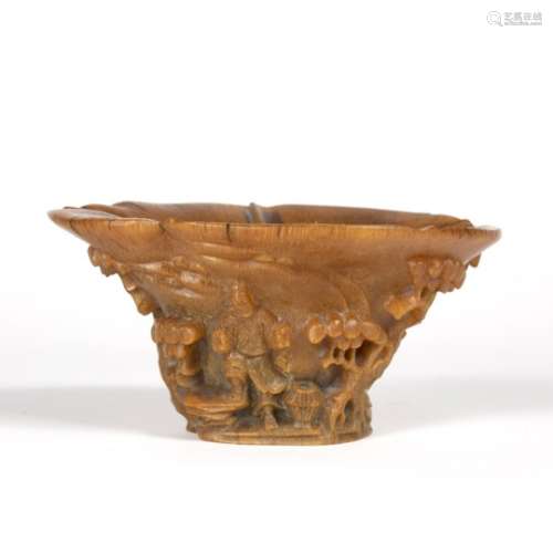 Rhinoceros horn libation cup Chinese, 19th Century the pale brown horn carved in relief with two