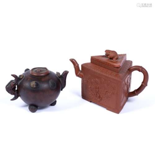 Two Yixing teapots Chinese, 19th Century the first with 'hundred fruits' decoration to the sides,