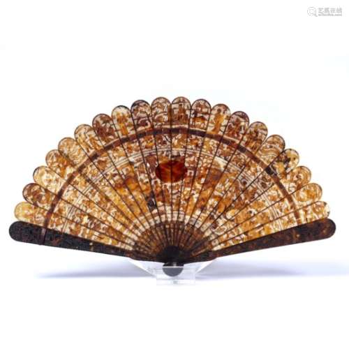 Tortoiseshell fan Chinese, 19th Century carved depicting figures in a river scene with foliate
