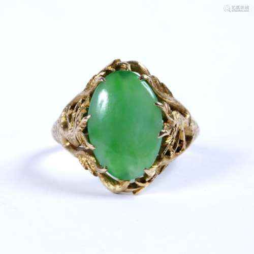 Jade single stone ring the oval jade cabochon in claw setting, between pierced and engraved dragon