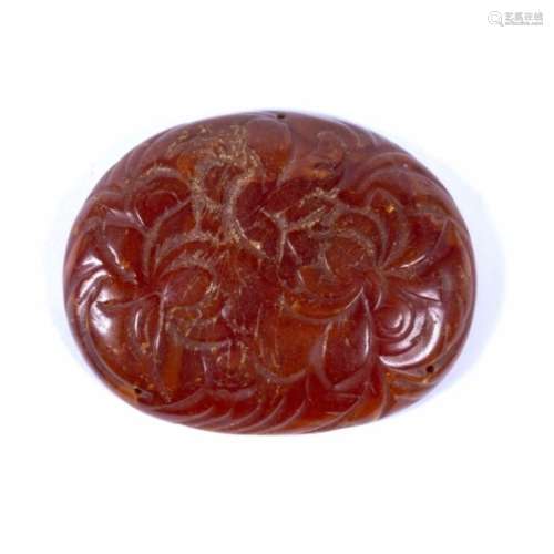 Amber pendant Chinese, 17th Century engraved with scrolling foliate design 4.5cm across