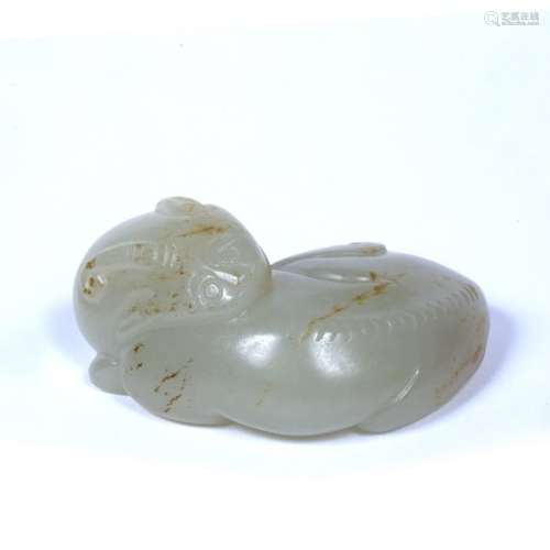 White jade pebble Chinese, 17th/18th Century carved as a single horned kirin reclining with head