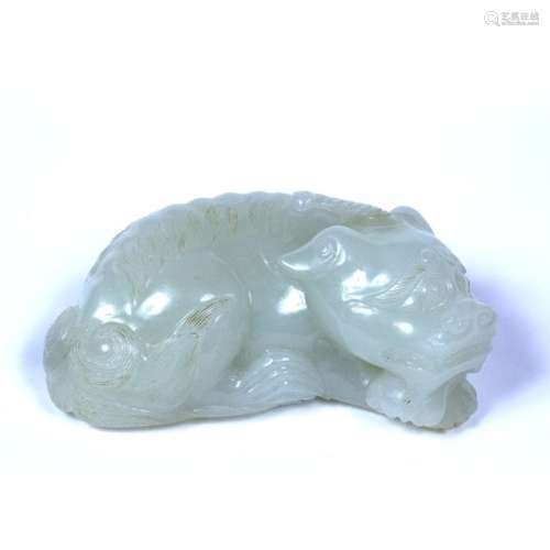 White jade pebble Chinese, 19th Century carved as a recumbent dog of fo with head to right resting