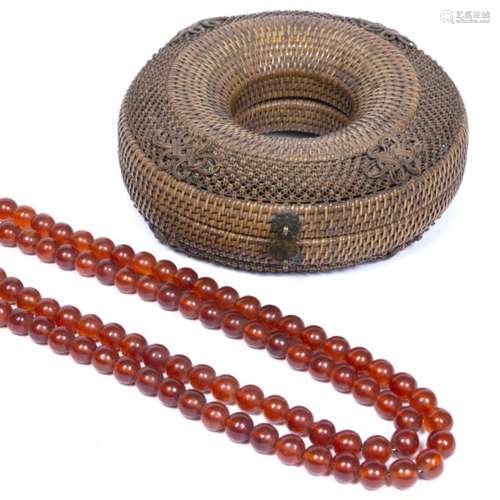 Amber bead necklace Chinese oval beads with a later wicker basket 72cm across