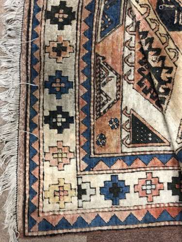 A MIDDLE EASTERN FRINGED CARPET