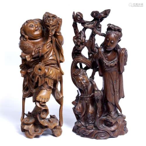 Two hardwood figures Chinese, circa 1900 one holding a dragon over his left shoulder 39cm high and