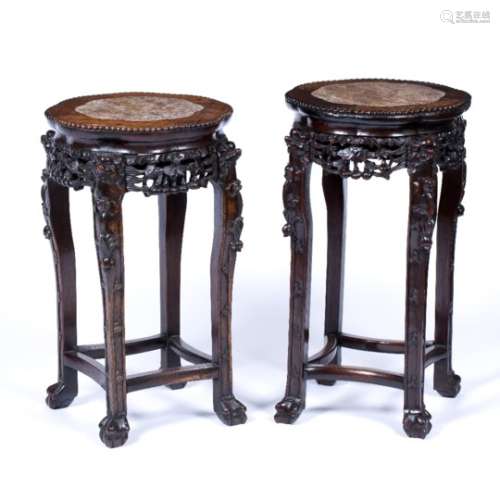 Matched pair of rosewood urn stands Chinese, late 19th Century with carved supports and inset marble