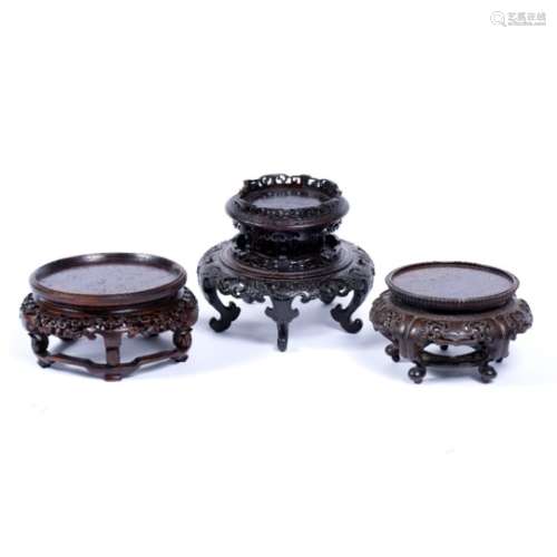 Three wooden vase stands Chinese the first of two tiered form decorated with pierced and other